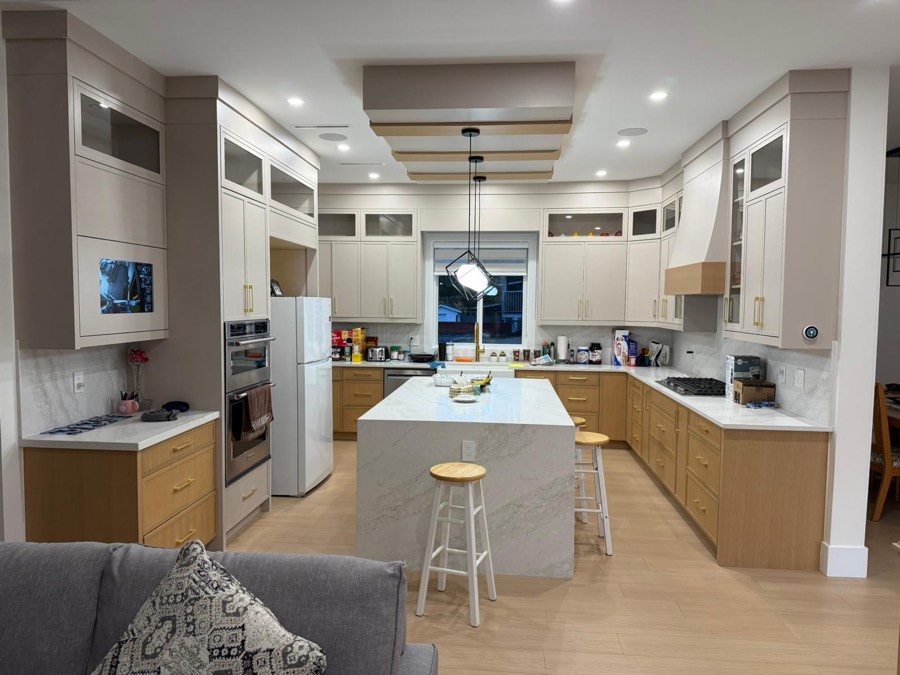 Open plan kitchen with pot lights and under cabinet lighting