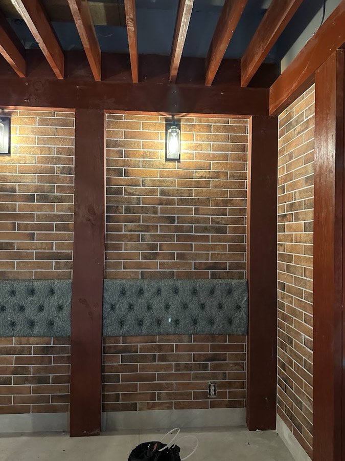 Brick and timber feature wall with wall mounted lighting